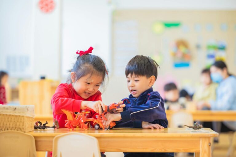 Two kids enjoy playing with toys in a lively kindergarten setting.